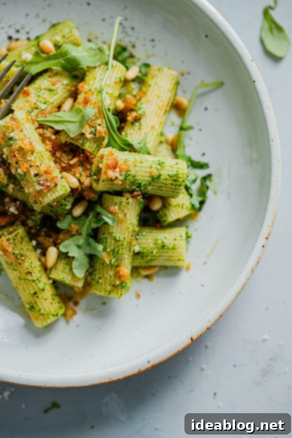 Vibrant Arugula Pesto Pasta with Golden Garlic Crumble 2 Arugula Pesto Pasta bowl garnished with Garlicky Breadcrumbs