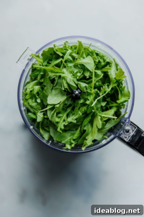 Vibrant Arugula Pesto Pasta with Golden Garlic Crumble 3 Step-by-step guide to making Arugula Pesto in a food processor
