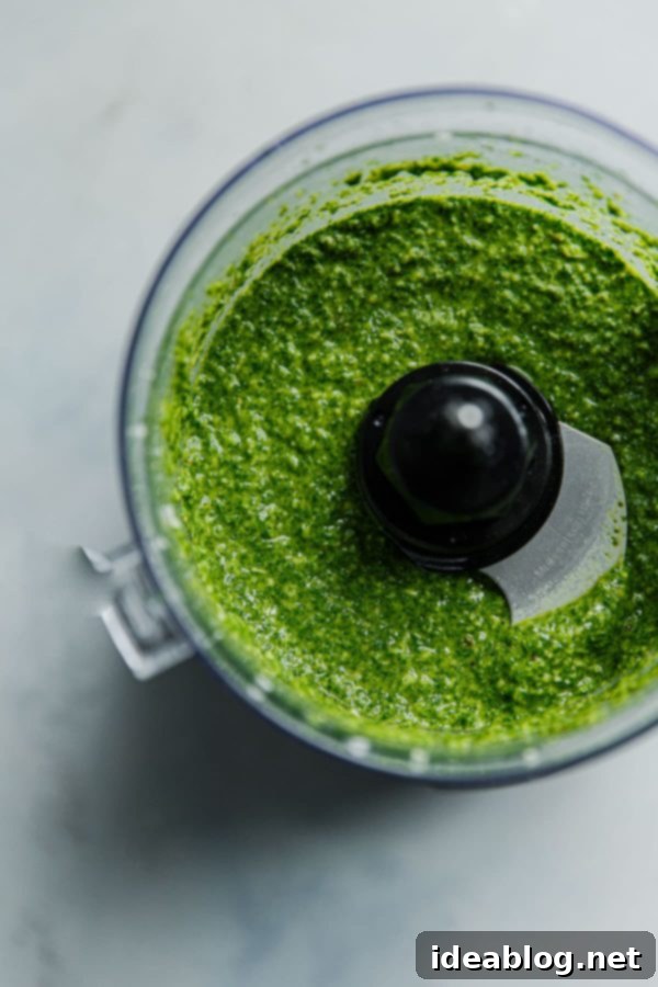 Vibrant Arugula Pesto Pasta with Golden Garlic Crumble 4 Arugula Pesto being blended in a food processor