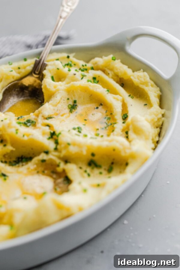 Experience the ultimate in comfort food with our Classic Yukon Gold Mashed Potatoes, meticulously prepared with heavy cream, rich unsalted butter, and seasoned to perfection with salt and pepper. Each serving is elegantly garnished with vibrant fresh chives, making these simple mashed potatoes an ideal side dish for Thanksgiving, holiday gatherings, and any meal requiring a touch of culinary excellence. Perfectly creamy, unbelievably buttery, and incredibly versatile, they pair wonderfully with virtually any main course. #thanksgiving #holiday #potatoes #abeautifulplate #Yukongold #recipe #sidedish #easyrecipes #creamy Classic Yukon Gold Mashed Potatoes with Fresh Chives, Cream, and Butter
