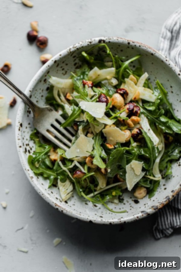 Shaved Fennel Arugula Salad with Hazelnuts, Parmesan, and Sherry Vinaigrette. A simple salad to enjoy year round. Great for everyday meals or special occasions! #abeautifulplate #salad #arugula #hazelnuts #parmesan #recipe  Shaved Fennel Arugula Salad with Hazelnuts, Parmesan, and Sherry Vinaigrette