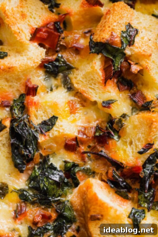 Overnight Vegetarian Breakfast Bake 4 A close-up of the baked Overnight Breakfast Strata, showing its golden-brown top and bubbling cheesy goodness.