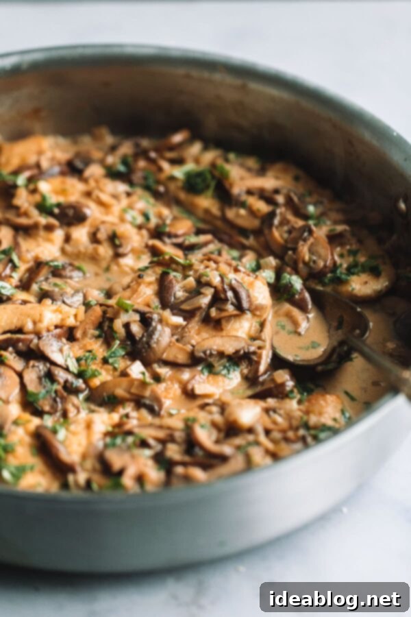 Healthier Chicken Marsala - Pan-seared chicken cutlets simmering in a rich Marsala mushroom sauce. Chicken Marsala with Mushroom Sauce in a Skillet