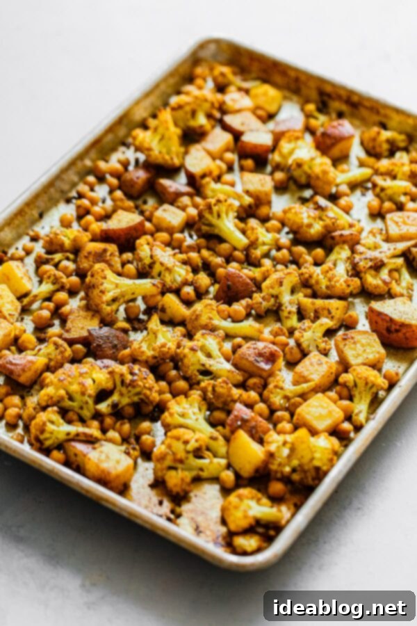 Sheet Pan Cauliflower Curry with Raita - this easy cauliflower curry, inspired by Indian Aloo Gobi, is prepared on a sheet pan and bulked up with canned chickpeas!  #vegetarian #glutenfree #curry #cauliflower #easyrecipes #sheetpan Sheet Pan Cauliflower Curry with Chickpeas - hearty and flavorful vegetarian meal