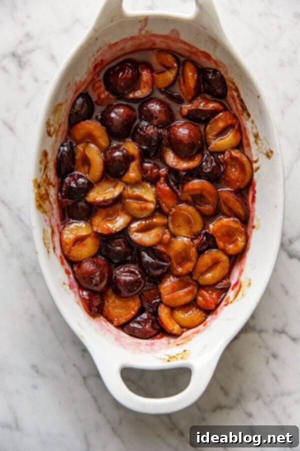 Slow-Roasted Plum Compote 7 Roasted plum compote in a baking dish, glistening with thick syrup