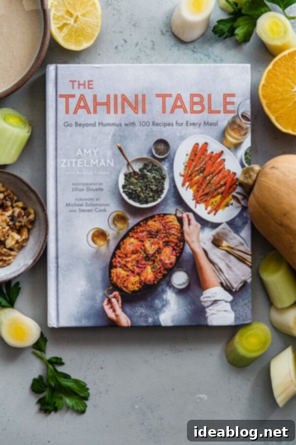 Zaatar Walnut Roasted Butternut Squash and Leeks with Orange Tahini 2 The Tahini Table Cookbook with all the recipe ingredients laid out beautifully.