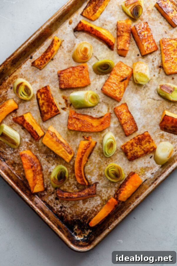 Zaatar Walnut Roasted Butternut Squash and Leeks with Orange Tahini 5 Roasted butternut squash and leeks spread out on a half sheet pan, perfectly caramelized.
