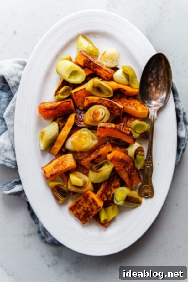 Zaatar Walnut Roasted Butternut Squash and Leeks with Orange Tahini 6 A serving platter filled with roasted butternut squash and leeks, artfully arranged.