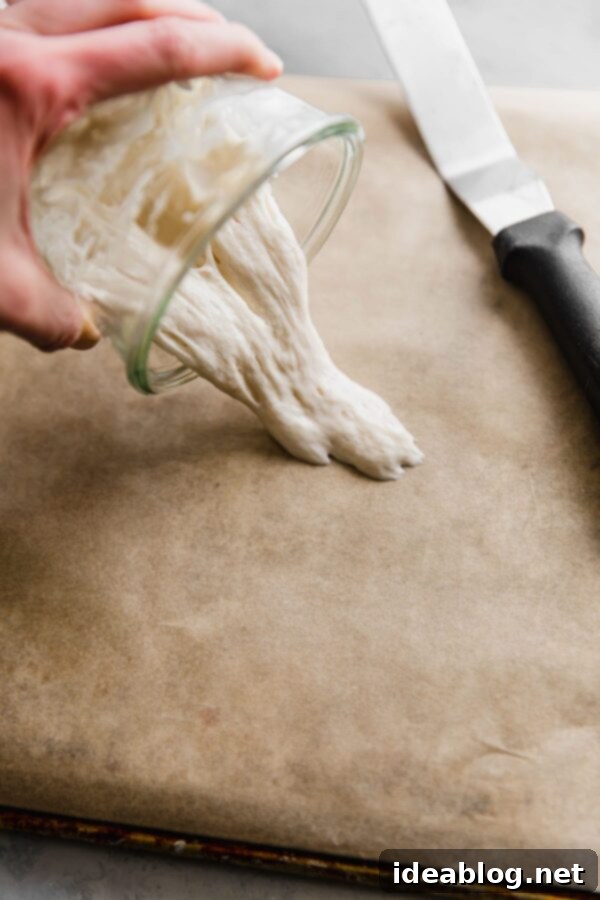 Ekşi Maya Kurutma ve Saklama Yöntemleri 6 pouring sourdough starter onto parchment paper for drying