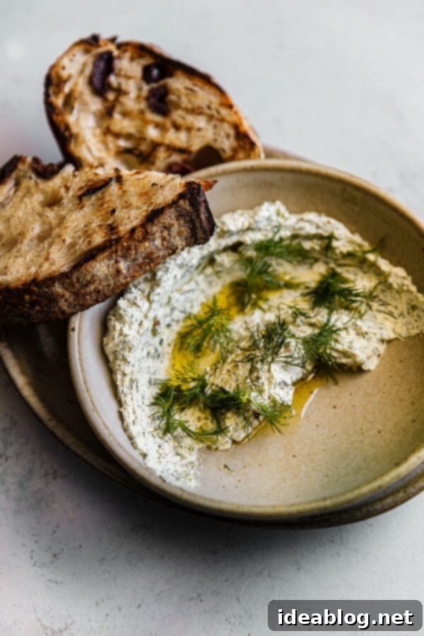 Whipped Garlic Herb Goat Cheese 6 Garlicky Herbed Goat Cheese Spread presented elegantly with grilled sourdough bread slices