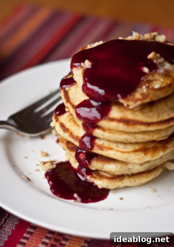Golden Minis with Blackberry Bliss 2 Fluffy Silver Dollar Pancakes Stack with Homemade Blackberry Syrup dripping over