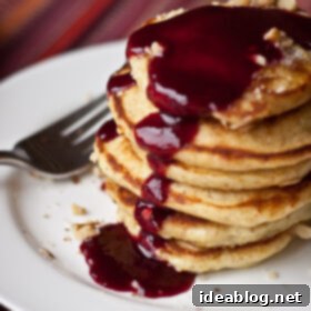 Golden Minis with Blackberry Bliss 6 Silver Dollar Pancakes with Blackberry Syrup on a white plate