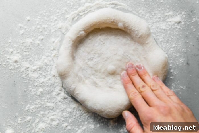 Artisan Sourdough Pizza Dough 23 How to Shape Pizza Dough by stretching on knuckles