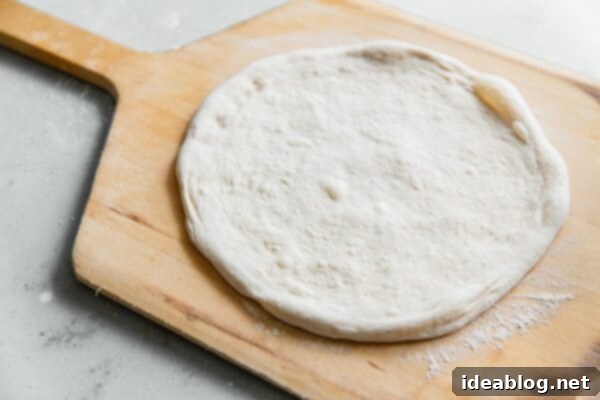 Artisan Sourdough Pizza Dough 43 Stretched Sourdough Pizza Dough on Wooden Pizza Peel
