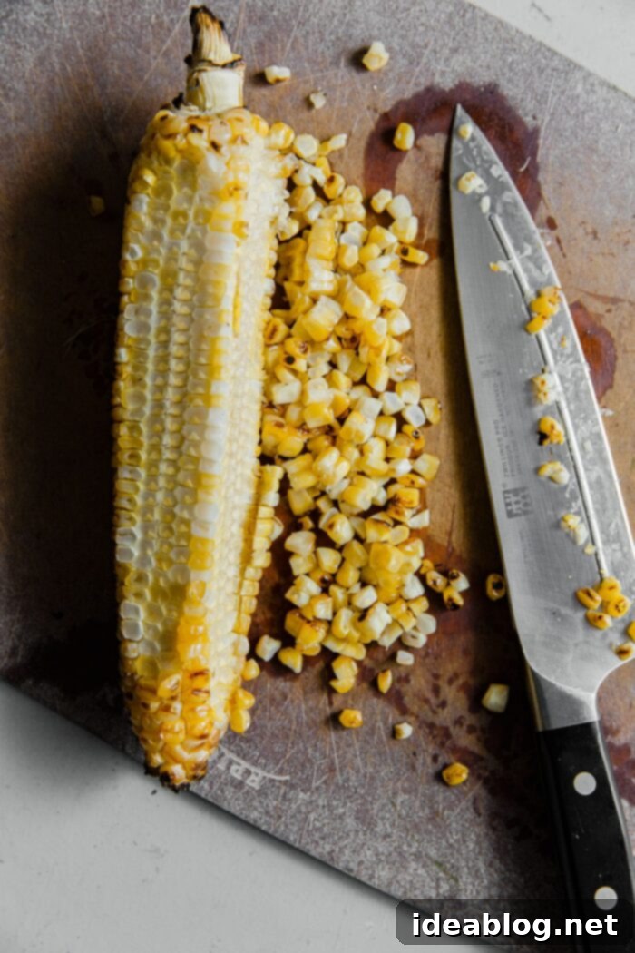 Charred Summer Vegetables Pistachio Pesto Pasta with Pecorino 13 Grilled Corn Being Cut off Cob