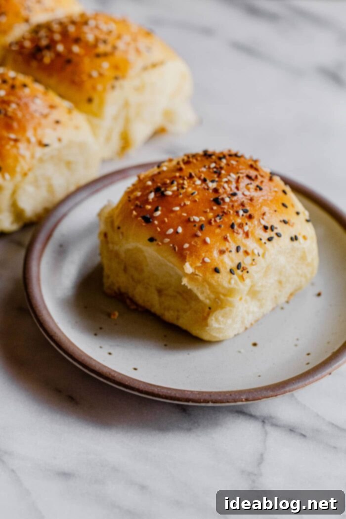 Ultimate Everything Dinner Rolls 2 Soft and fluffy Everything Dinner Roll on a plate, ready to be enjoyed.
