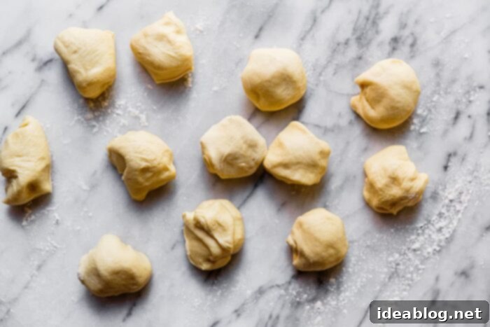 Ultimate Everything Dinner Rolls 12 Individual portions of dough after dividing.