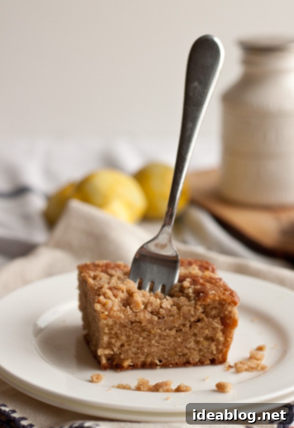 Zesty Lemon Streusel Bake 4 Lemon Crumb Cake on a white serving plate