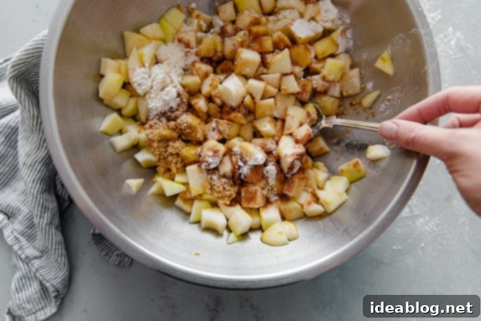 Golden Pear Crumble Delight 5 Bowl of freshly chopped pear pie filling, coated with spices and lemon juice