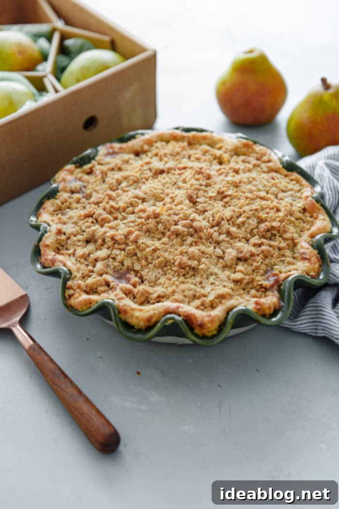 Golden Pear Crumble Delight 6 Close-up of a beautifully baked pear pie with a thick, golden streusel topping
