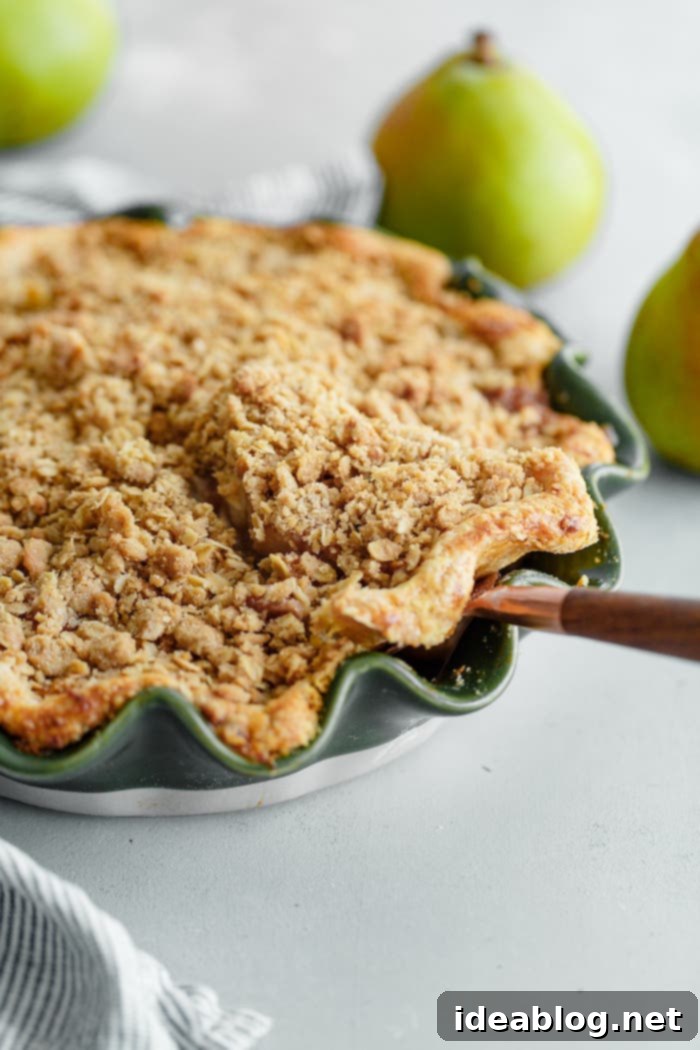 Golden Pear Crumble Delight 9 Whole baked pear pie with streusel topping on a cooling rack
