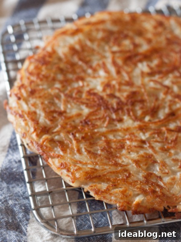 Smoked Salmon & Potato Tartine 5 Close-up of grated potato darphin cooking in a pan