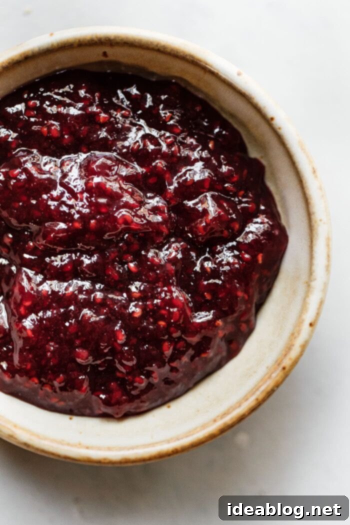 Rustic Raspberry Hazelnut Crumb Bake 4 A jar of St. Dalfour Red Raspberry Fruit Spread, highlighting its premium quality and natural ingredients.