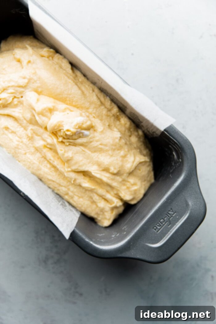 Zesty Lemon Loaf 6 Lemon loaf cake batter in a prepared loaf pan, ready for baking in the oven.
