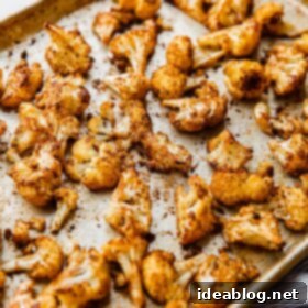 Roasted Cauliflower with Warm Spices 11 Beautifully spiced roasted cauliflower florets on a sheet pan