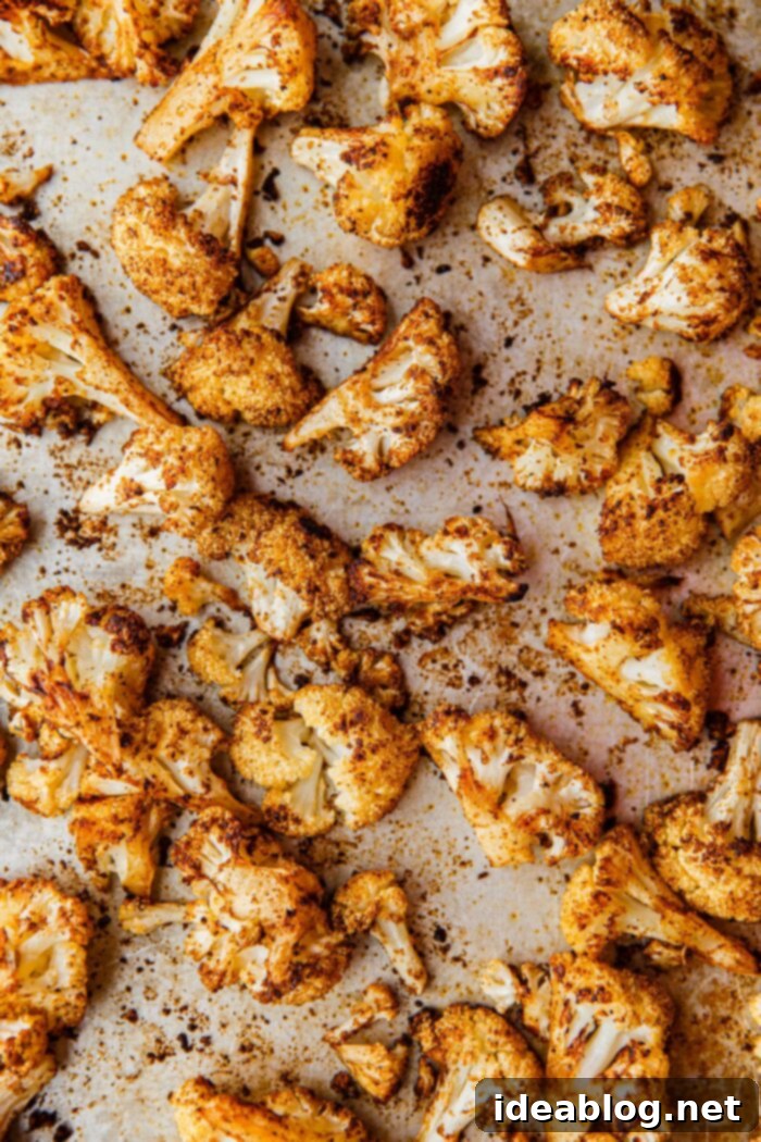 Roasted Cauliflower with Warm Spices 4 Beautifully spiced cauliflower florets spread in a single layer on a sheet pan, ready for roasting