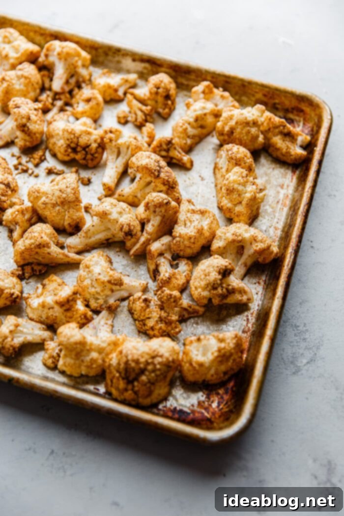 Roasted Cauliflower with Warm Spices 8 Close-up of cauliflower florets on a baking sheet, positioned flat-side down for maximum caramelization