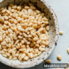 How to Perfectly Toast Pine Nuts 9 Raw Pine Nuts in a small bowl, ingredient for toasting