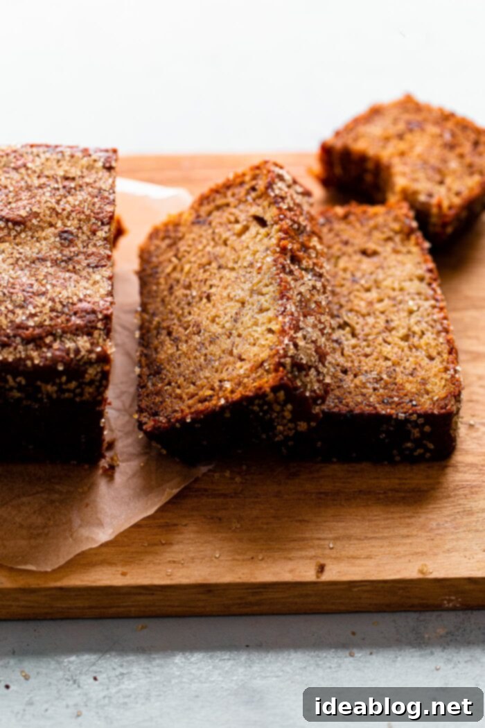 Ultimate Moist Banana Bread 2 Perfectly sliced, incredibly moist banana bread with a crunchy turbinado sugar topping on a white plate