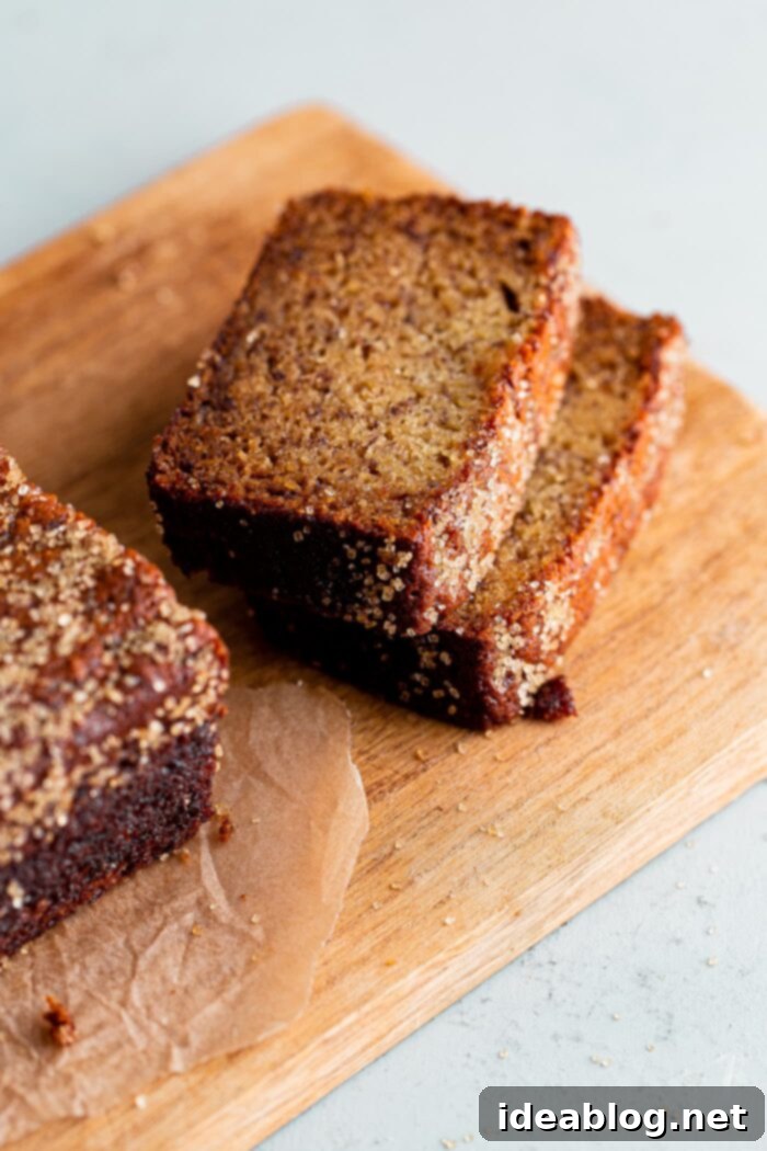 Ultimate Moist Banana Bread 11 A whole loaf of moist banana bread topped with sparkling turbinado sugar, cooling on a wire rack