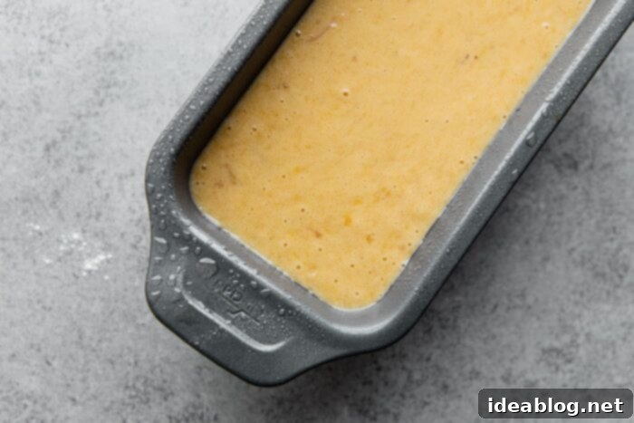 Ultimate Moist Banana Bread 9 Moist banana bread batter poured into a parchment-lined loaf pan, ready for baking