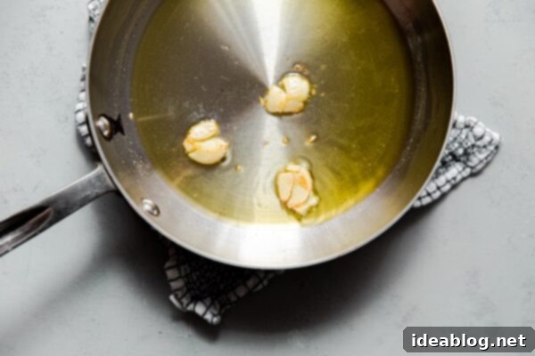 Irresistible Garlic Crunch 10 Smashed Garlic Cloves in Skillet with Olive Oil