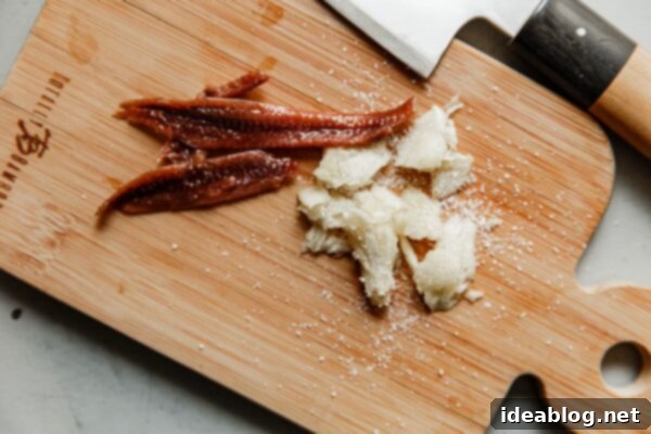 Caesar Dressing Pick Your Perfect Batch 24 Anchovy Fillets and Smashed Garlic on Cutting Board