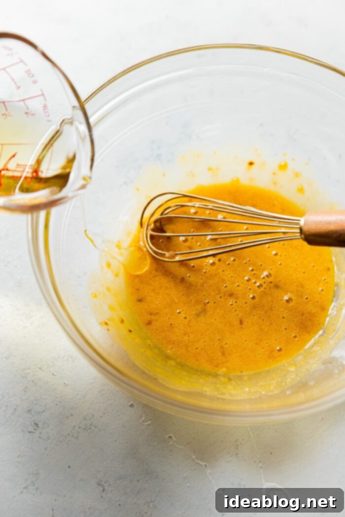 Caesar Dressing Pick Your Perfect Batch 9 Pouring Oil into Caesar salad Dressing
