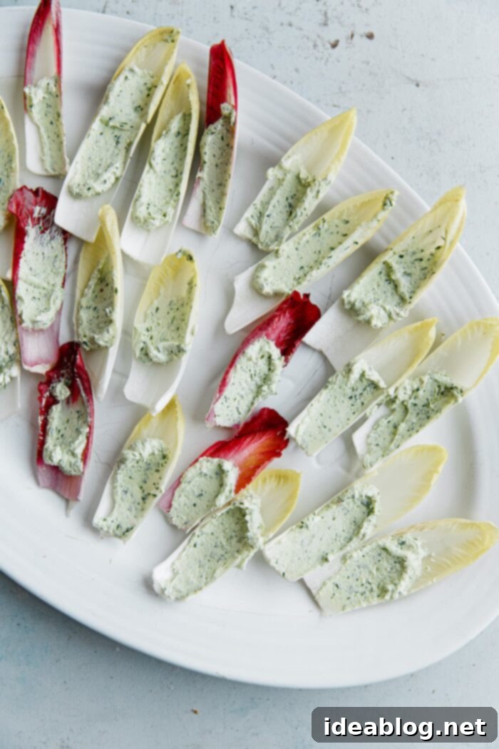Zesty Beet and Goat Cheese Endive Boats 8 Spreading goat cheese in endive leaves