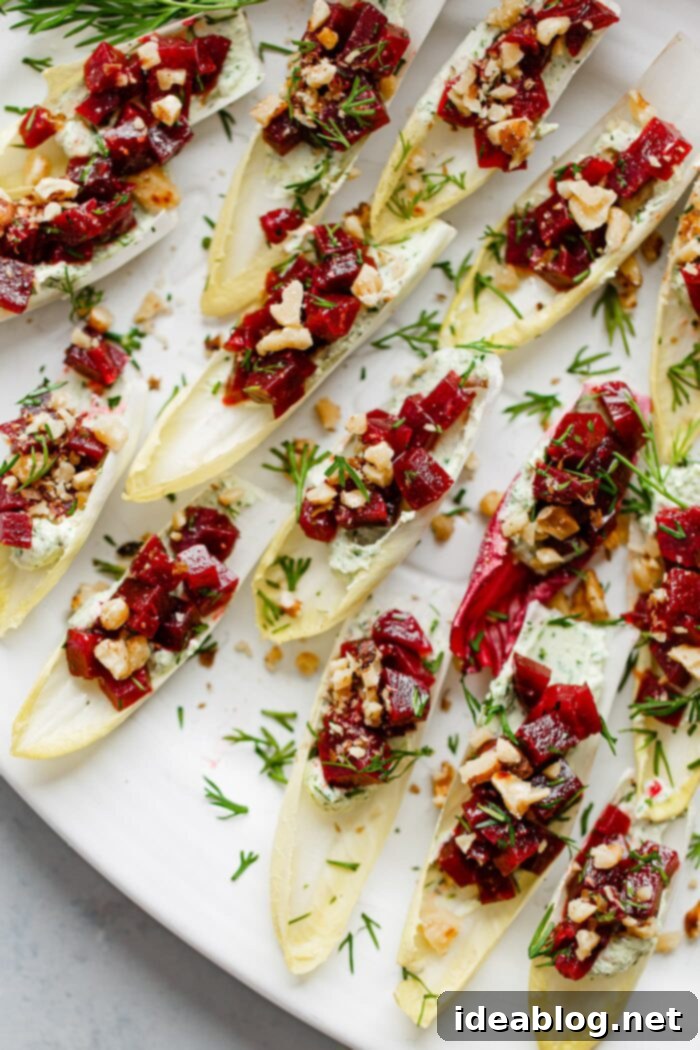 Zesty Beet and Goat Cheese Endive Boats 9 Beet and Goat Cheese Endive Bites on a platter