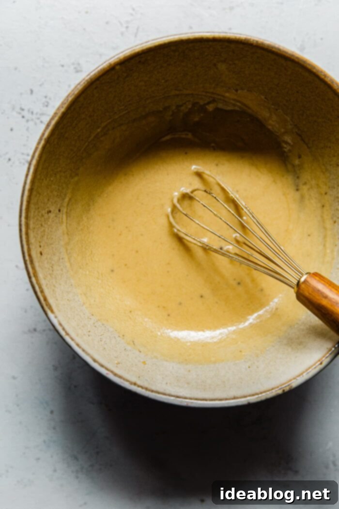 Autumn Harvest Farro Bowl 10 A bowl of smooth and creamy maple tahini dressing, ready to be poured