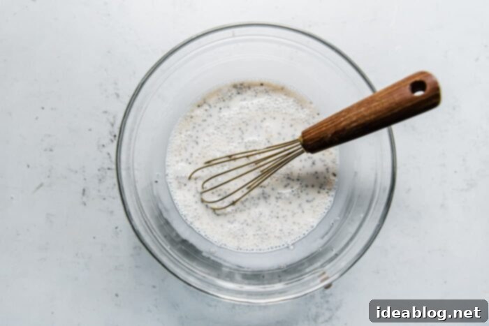 Effortless Overnight Chia Pudding 7 Mixing chia pudding ingredients in a jar.