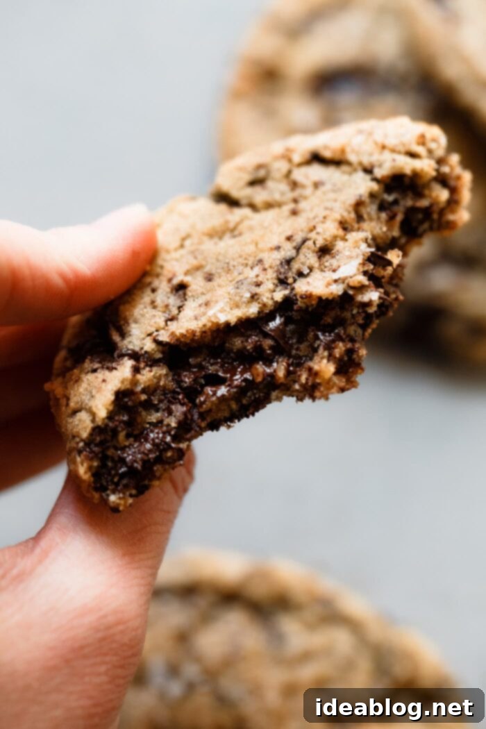 Ultimate Chocolate Chunk Cookies 9 Close-up of a chocolate chunk cookie, showing its chewy interior and melted chocolate pools.