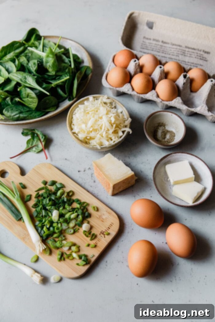 Fluffy Cheesy Eggs with Fresh Greens 4 Ingredients for Cheesy Scrambled Eggs with Greens laid out on a board