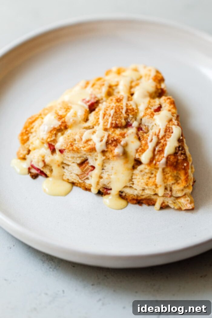 Zesty Orange Glazed Rhubarb Scones 11 Stack of glazed Rhubarb Scones with orange zest, ready to be served.