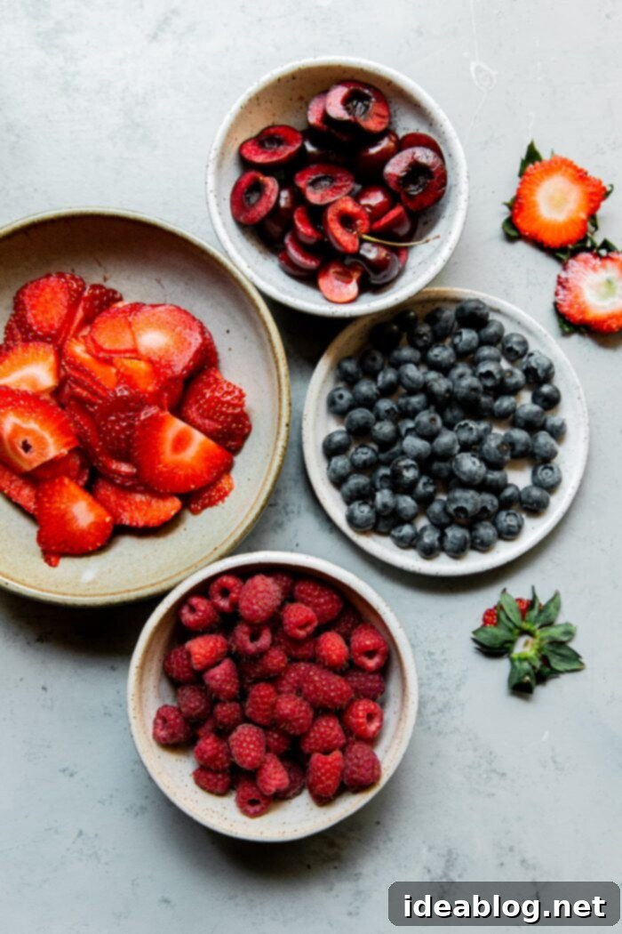 Festive Flag Dessert 5 Fresh ingredients for making an American Flag Cake, including berries, cream, and preserves