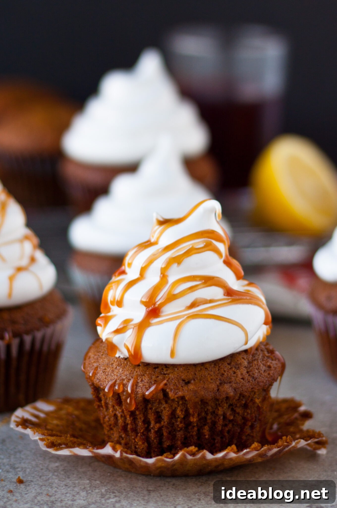 Pomegranate-Kissed Gingerbread Clouds 2 Gingerbread Cupcakes with Marshmallow Frosting and Pomegranate Caramel, perfectly frosted and drizzled