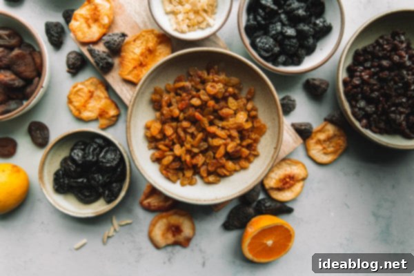 A traditional moist fruit cake made with rum soaked dried fruit, citrus zest, and candied ginger. The best fruit cake recipe you’ll ever make! #abeautifulplate #holiday #christmas #fruitcake #cake #recipe Unsweetened Dried Fruit in Bowls