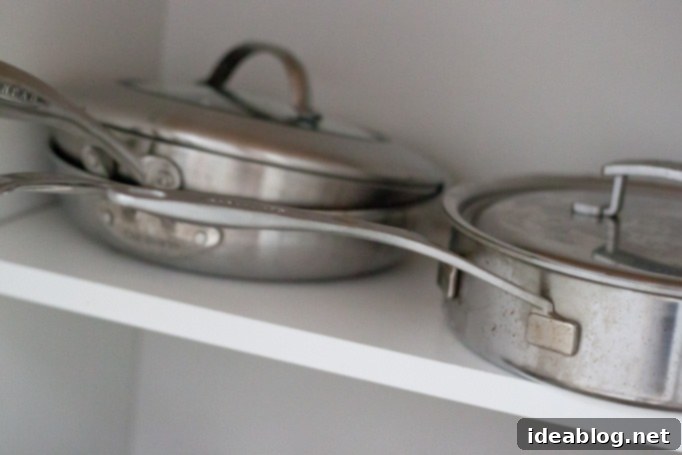 Our Kitchen Unveiled 6 Open cabinet revealing neatly organized spices and bulk storage items in mason jars