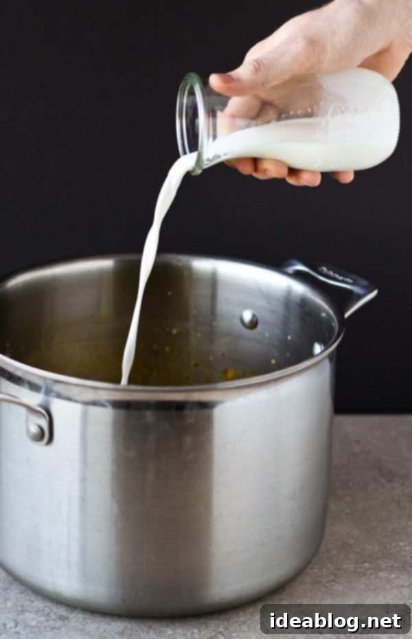 Golden Spiced Cauliflower Bisque 4 Cream Pouring into Soup Pot